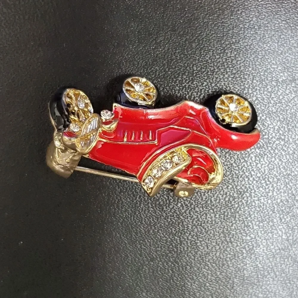 Gold tone red enamel antique car brooch